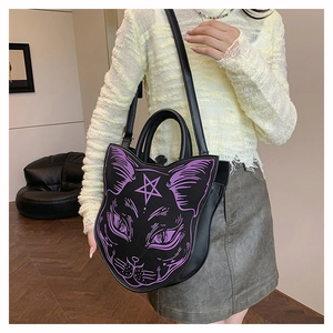 Gothic black cat shaped crossbody bag with purple graphic and pentagram on a model