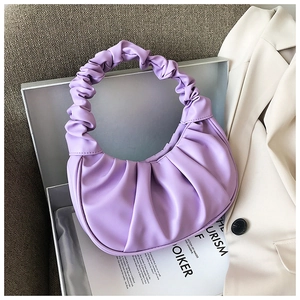Macro view of lavender purple pleated hobo bag with a soft ruched handle in a gift box