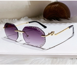 Detail of rimless gradient purple sunglasses featuring a golden horse head metal relief