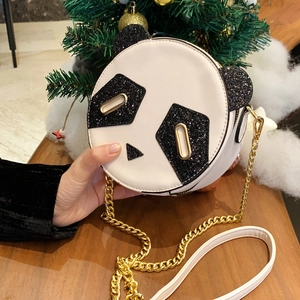 Sparkly sequin panda crossbody bag with gold chain strap held in a gift setting