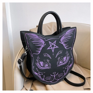 Detail of creative black gothic cat-shaped handbag with purple printed facial features