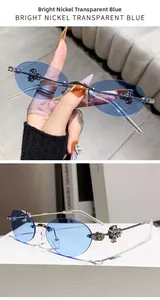 Detailed close-up of rimless oval sunglasses with diamond metal cross and blue lenses