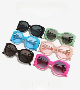 Flat lay of retro oversized sunglasses in six trendy colors with cat-eye resin frames