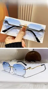 Close-up of frameless blue gradient sunglasses with jagged edges and golden metal hinges
