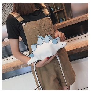 Detail view of mini dinosaur crossbody bag in pearl white and sky blue leather