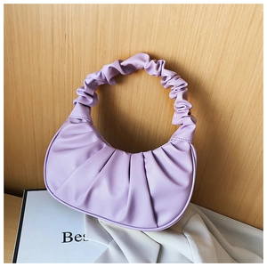 Detailed view of purple ruched dumpling bag with soft pleats and cloud texture on leather