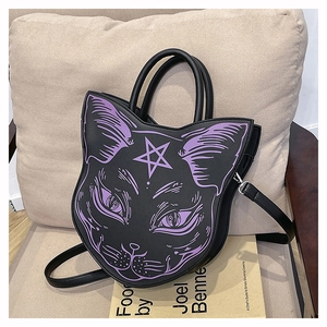Macro view of Gothic black leather cat-shaped handbag with purple occult totem