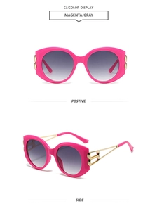 Detail of magenta oversized sunglasses with gold geometric hollow temples and gray lenses