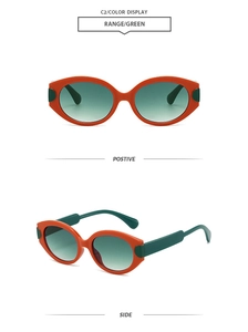 Detail view of retro oval sunglasses with orange frames and green lenses showing front and side