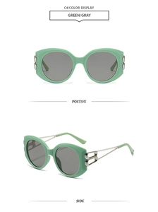 Detail of mint green cat-eye sunglasses with unique silver double-ring chain metal temples