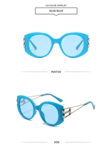Detail view of large blue sunglasses frame featuring silver double-ring temple metal piece