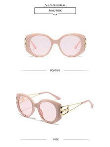 Detail view of pink large frame sunglasses with golden metal hinges and pink lenses