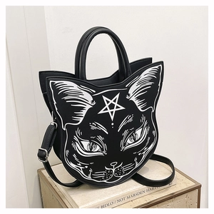 Detail of gothic cat face handbag featuring white star prints and silver hardware accents