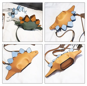 Detail of dinosaur crossbody bag showing zipper closure, inner lining and various colors