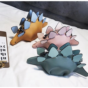 Detailed view of colorful stegosaurus mini bags featuring vibrant PU leather and 3D scales