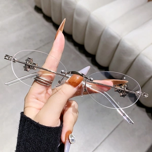 Fashion rimless oval sunglasses with diamond-studded cross metal floral temple accents