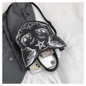 Detail showing storage capacity of a black gothic cat-shaped punk handbag with stars