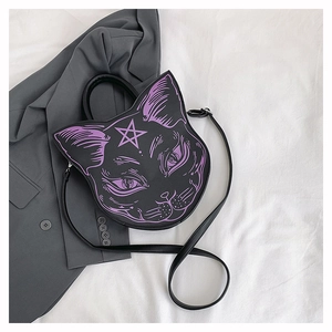 Close-up of black cat shaped crossbody bag featuring purple feline facial prints