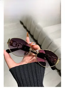 Detail of gradient purple lenses and golden metal double-ring hinges on punk sunglasses