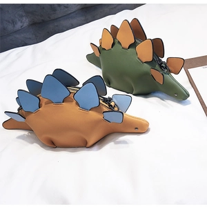 Detail of colorful dinosaur PU leather crossbody bags with metal zippers on white background