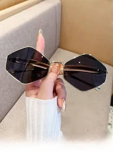 Close-up of geometric hexagon sunglasses with metal frames and dark purple lenses