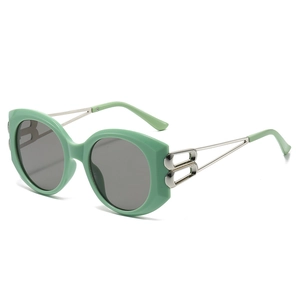 Fashionable oversized mint green sunglasses with dark grey lenses and silver metal hinges