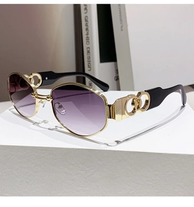 Detail of gold metal frame sunglasses featuring purple gradient lenses and interlocking hinges