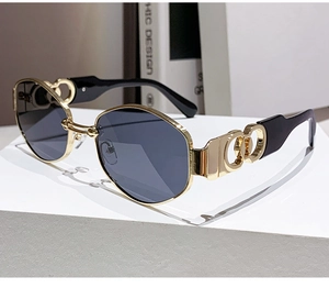 Detailed macro view of gold hollow-out temples and polygon metal frame sunglasses