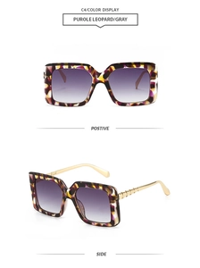 Detail view of purple leopard square sunglasses with gold bamboo-style metal temples