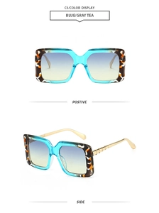Detail of blue tortoiseshell square sunglasses with gold metal temples and gradient lenses