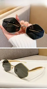 Detailed macro view of geometric golden metal frame sunglasses with green G15 lenses