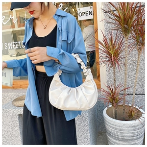 Fashionable white ruched crescent bag with scrunchie handle for street style look