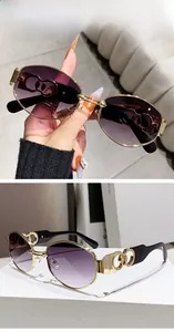 Detail of fashion punk polygon sunglasses with hollow metal temples and double grey lens