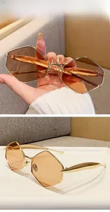 Detailed macro view of geometric golden metal sunglasses with champagne tinted lenses