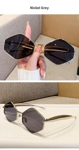 Detail view of large geometric polygon sunglasses with nickel frame and grey lenses