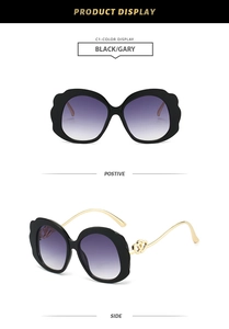 Detail of fashion oval sunglasses with wavy large frame and purple gradient lenses