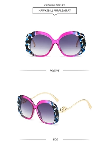 Detail view of oval tortoise purple frames with gold metal temples and heart accents