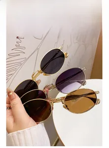 Close-up of three stylish oval sunglasses with slim gold metal frames and tinted lenses