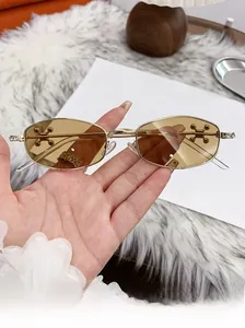 Close-up of vintage metal sunglasses featuring unique cross-shaped side decorations