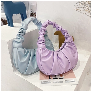 Close-up of pleated soft synthetic leather texture on a stylish dumpling shoulder bag