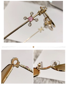 Detailed macro view of gold metal sunglasses frame with pink rhinestones and hinges