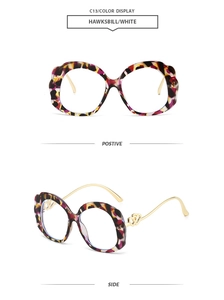 Detail of oval frames with tortoiseshell pattern and gold temples with double heart cutout