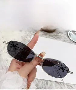 Detail of bright nickel polygon sunglasses with diamond accents on the metal temples