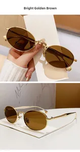 Detail of retro oval bright gold sunglasses with deep brown lenses for outdoor use