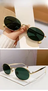 Detailed side view of bright gold metal oval sunglasses with dark green lenses