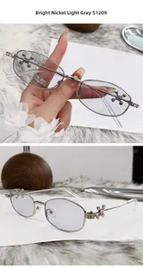 Detail of bright nickel polygon sunglasses with cross-shaped rhinestone accents and gray lenses