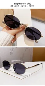 Detailed macro view of oval sunglasses with bright nickel metal frames and dark grey lenses