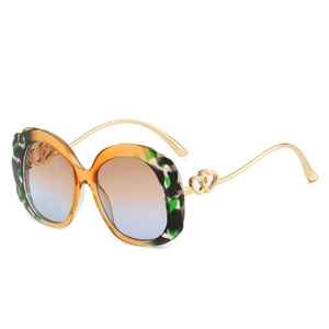 Fashionable oversized oval sunglasses with tortoiseshell pattern and heart hinge detail