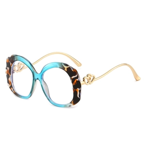 Fashionable oversized oval sunglasses with blue tortoise frames and gold wavy temples