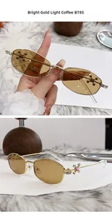 Detail of polygonal gold sunglasses with crystal cross decor and light coffee lenses